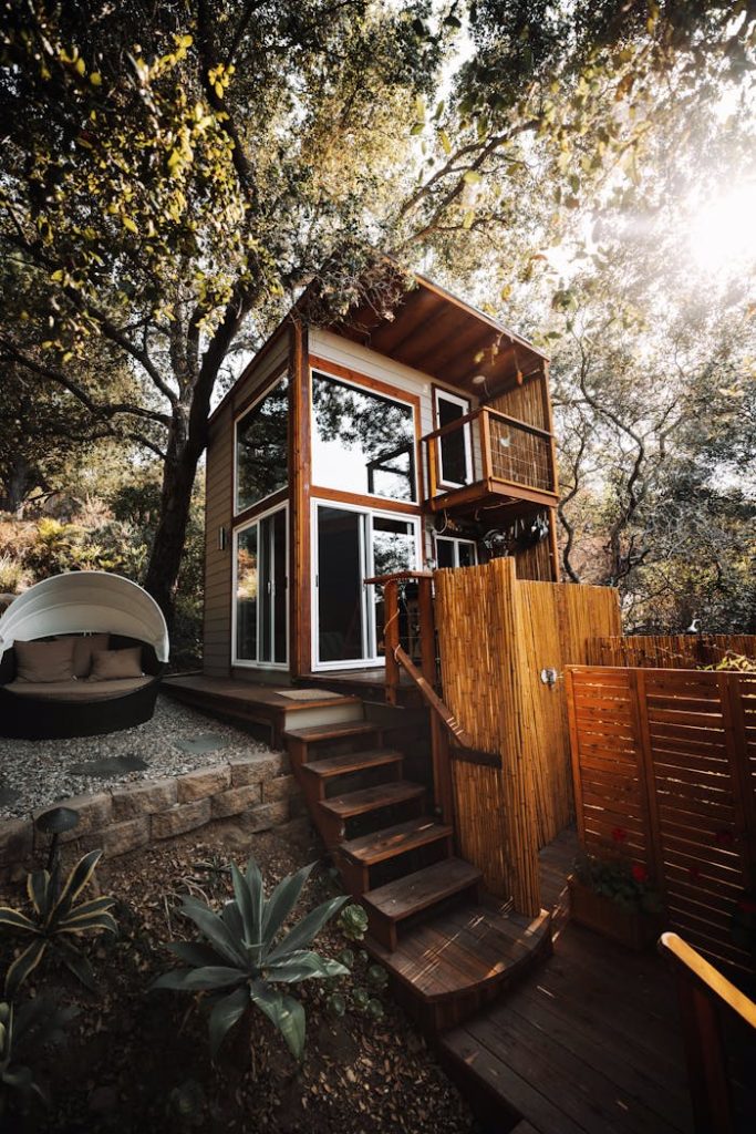 pexels-photo-8755443 A stylish wooden cabin amidst green foliage, ideal for a serene getaway.